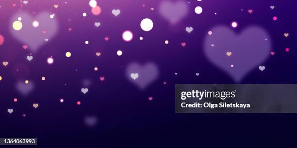 heart shaped sequins on purple background - glowing heart stock pictures, royalty-free photos & images