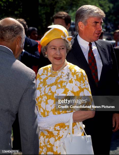 View of British monarch Queen Elizabeth II as she visits a newly completed affordable housing project on Drake Place SE, Washington DC, May 15, 1991....