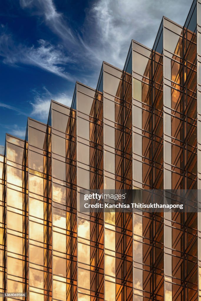 Golden abstract mirror texture, modern architecture facade, business concept