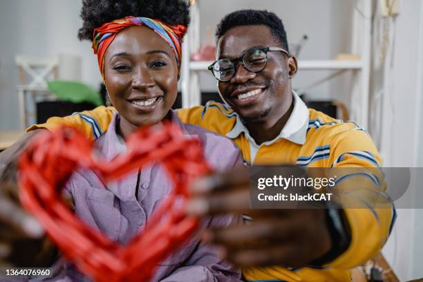 a lovely young couple holding heart as a symbol of love - valentines african american 個照片及圖片檔