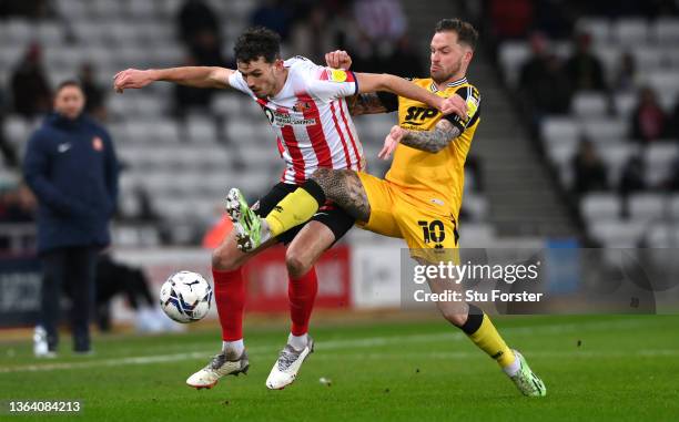 Lincoln player Chris Maguire challenges Tom Flanagan of Sunderland during the Sky Bet League One match between Sunderland and Lincoln City at Stadium...