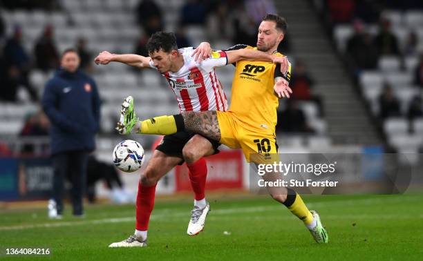 Lincoln player Chris Maguire challenges Tom Flanagan of Sunderland during the Sky Bet League One match between Sunderland and Lincoln City at Stadium...
