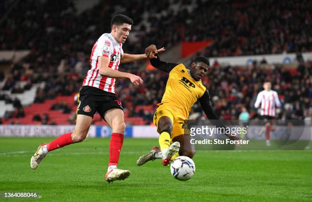 Lincoln player TJ Eyoma challenges Ross Stewart of Sunderland during the Sky Bet League One match between Sunderland and Lincoln City at Stadium of...