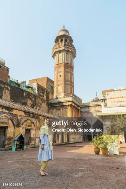 woman in hijab  walking in mosque - minaret stock pictures, royalty-free photos & images