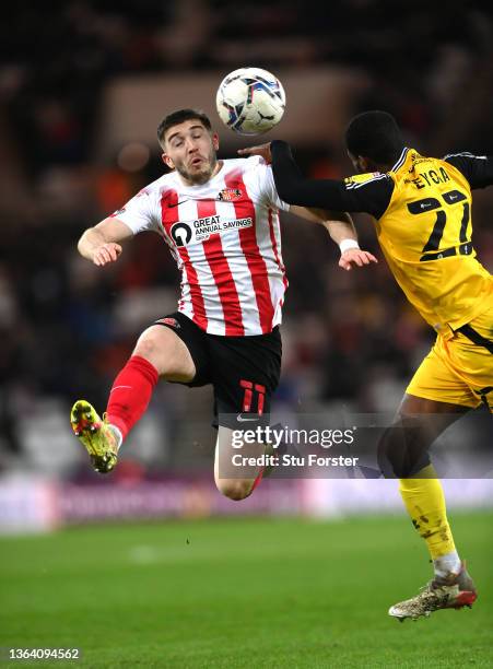 Lincoln player TJ Eyoma challenges Lynden Gooch of Sunderland during the Sky Bet League One match between Sunderland and Lincoln City at Stadium of...