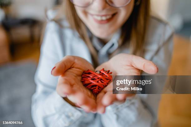 close up of a female hands holding the heart as a symbol of love - showing empathy stock pictures, royalty-free photos & images