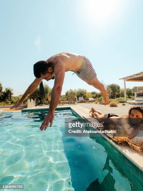 pool days - jumping sun stock pictures, royalty-free photos & images