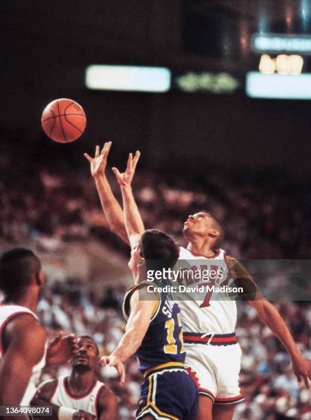 Kevin Johnson of the Phoenix Suns and John Stockton of the Utah Jazz vie for a ball during an NBA game Lakers played on April 9, 1990 at the Arizona...