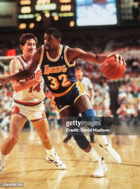 Magic Johnson of the Los Angeles Lakers plays in an NBA game against the Phoenix Suns on April 6, 1990 at the Arizona Veterans Memorial Coliseum in...