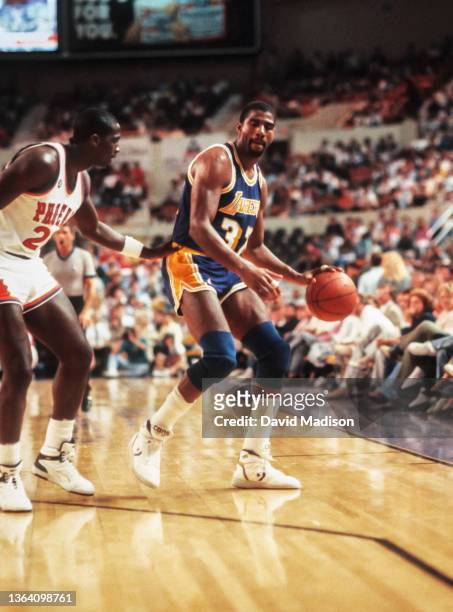 Magic Johnson of the Los Angeles Lakers plays in an NBA game against the Phoenix Suns on April 6, 1990 at the Arizona Veterans Memorial Coliseum in...