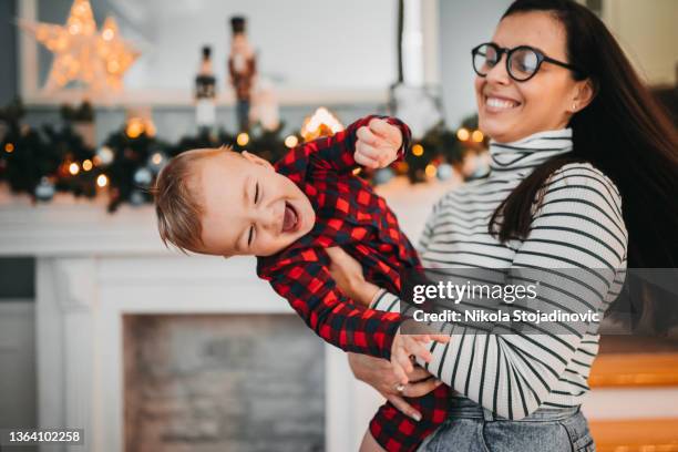 mom and baby boy are enjoying christmas - winter baby stockfoto's en -beelden