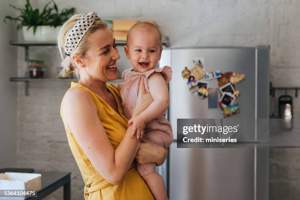 mother and daughter: having fun in the kitchen - connected fridge stock pictures, royalty-free photos & images