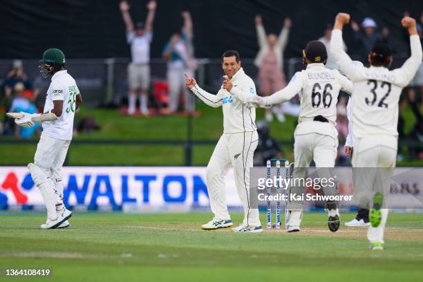 Ross Taylor of New Zealand is congratulated by team mates after dismissing Ebadot Hossain Chowdhury of Bangladesh during day three of the Second Test...