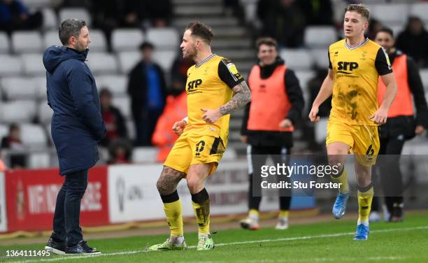 Lincoln player Chris Maguire celebrates his opening goal in front of Sunderland manager Lee Johnson during the Sky Bet League One match between...