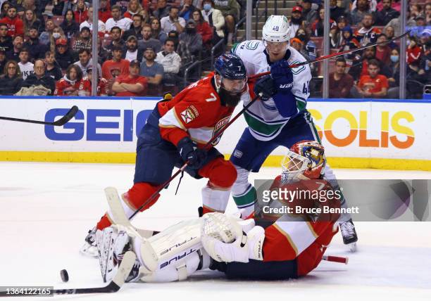 Radko Gudas and Sergei Bobrovsky of the Florida Panthers defend against Elias Pettersson of the Vancouver Canucks during the second period at the...