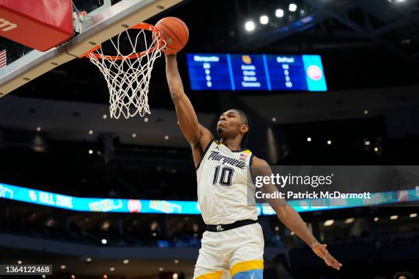Justin Lewis of the Marquette Golden Eagles dunks against the DePaul Blue Demons in the second half at Fiserv Forum on January 11, 2022 in Milwaukee,...
