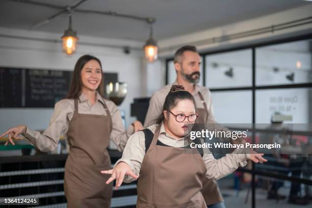 coffee shop worker dancing in the shop - busy coffee shop stock pictures, royalty-free photos & images