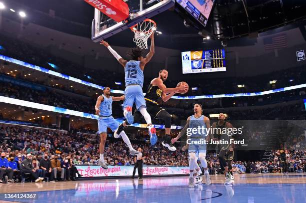 Stephen Curry of the Golden State Warriors goes to the basket against Ja Morant of the Memphis Grizzlies during the first half at FedExForum on...