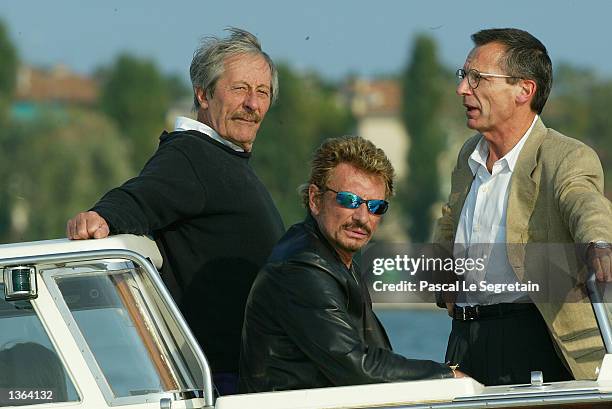 French actor Jean Rochefort, French actor and music star Johnny Hallyday and director Patrice Leconte arrive at the Lido during the 59th Venice Film...