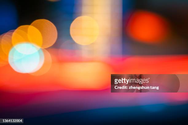 lights of crowded traffic on city street at night - street light stock pictures, royalty-free photos & images