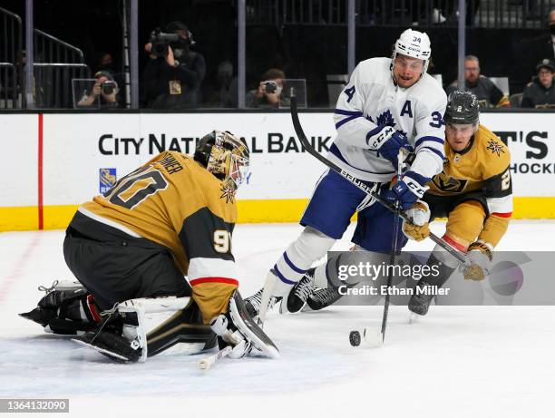 Robin Lehner of the Vegas Golden Knights defends the net as Auston Matthews of the Toronto Maple Leafs tries to get a shot off under pressure from...