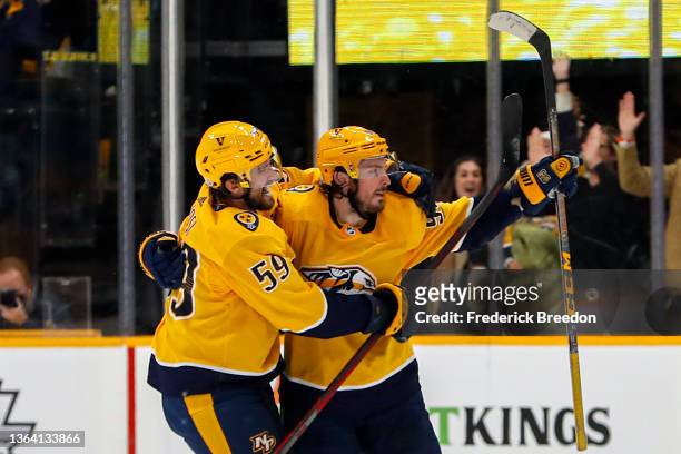 Matt Duchene of the Nashville Predators is congratulated by teammate Roman Josi after scoring the game winning goal in a 5-4 overtime victory over...