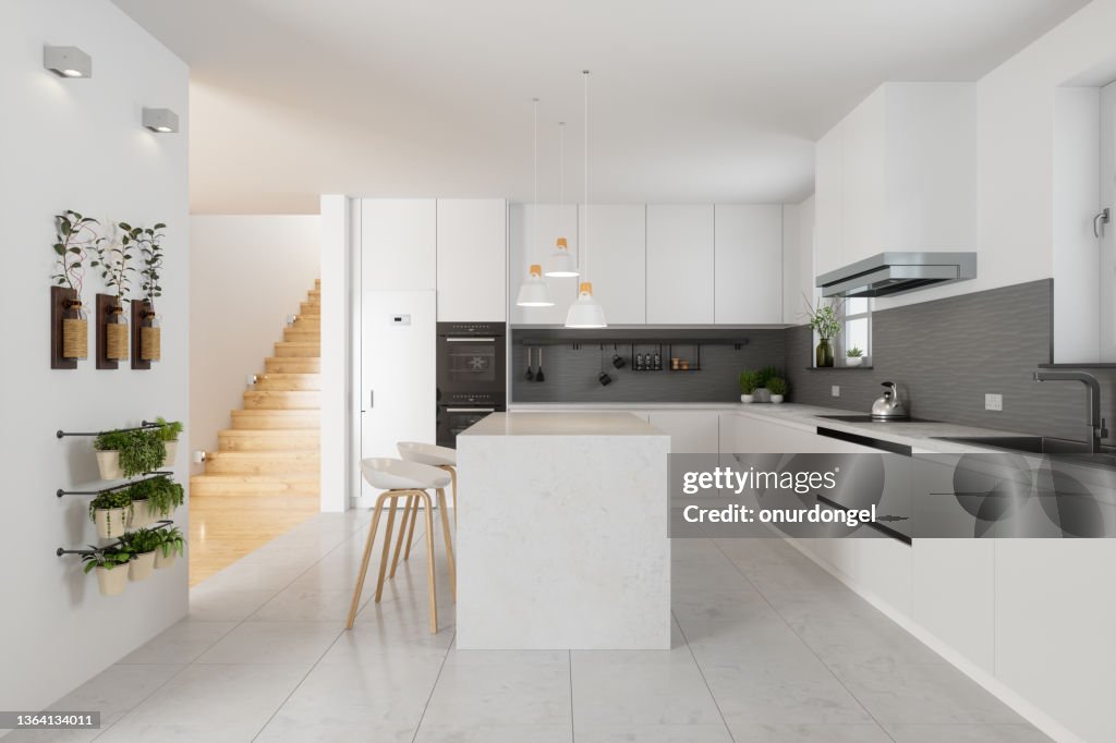 Modern Kitchen Interior With White Cabinets, Kitchen Island, Stools And Staircase In Corridor