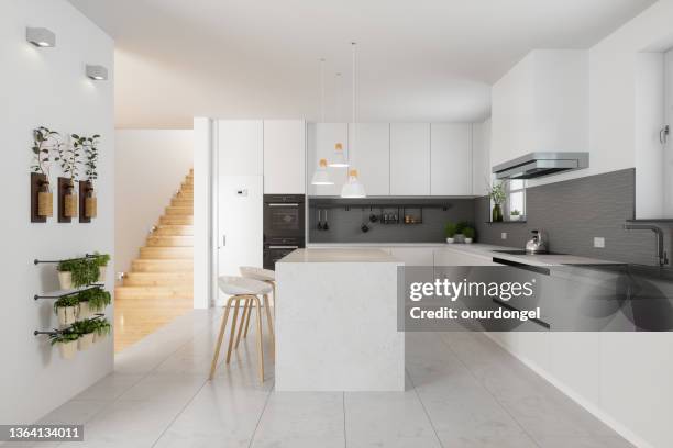 modern kitchen interior with white cabinets, kitchen island, stools and staircase in corridor - kakelplatta bildbanksfoton och bilder