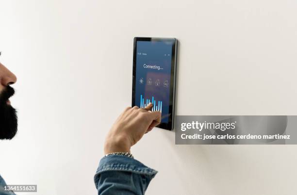 smart home, hand using control panel - indagini di clima foto e immagini stock