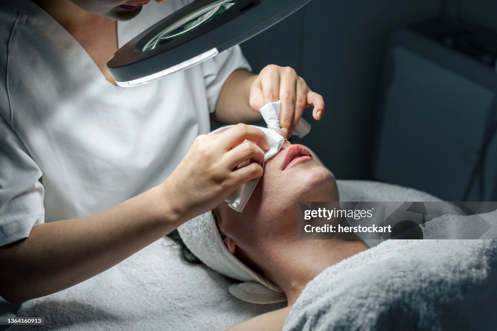 Dermatologist doing facial care against acnes
