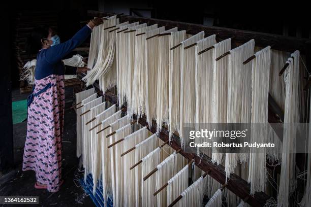 Worker dries noodles at Marga Mulja factory on January 12, 2022 in Surabaya, Indonesia. Longevity white noodles are a popular dish that is...