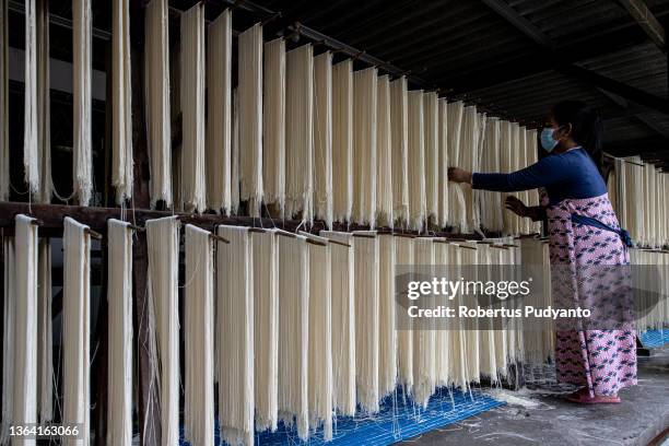 Worker dries noodles at Marga Mulja factory on January 12, 2022 in Surabaya, Indonesia. Longevity white noodles are a popular dish that is...