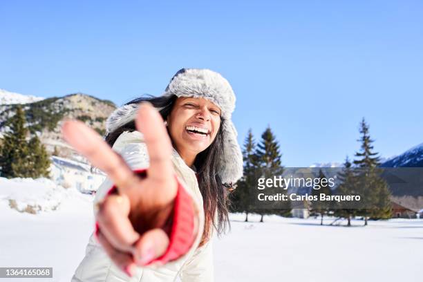 beautiful and smiling young woman making the peace sing to the camera. - cnd sign stock pictures, royalty-free photos & images