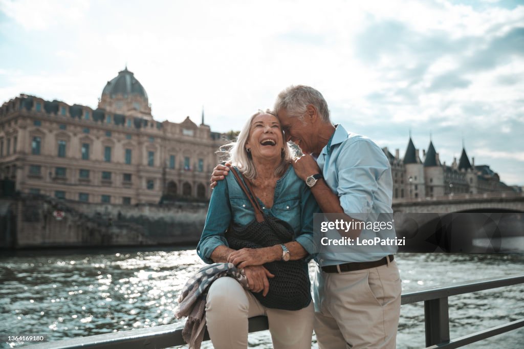Seniors taking a break in Paris relaxing by the Seine River in Paris