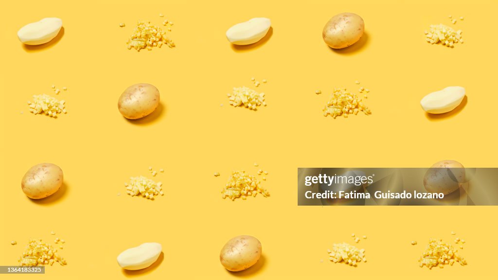 Repetition of elements of various potato states on a yellow background