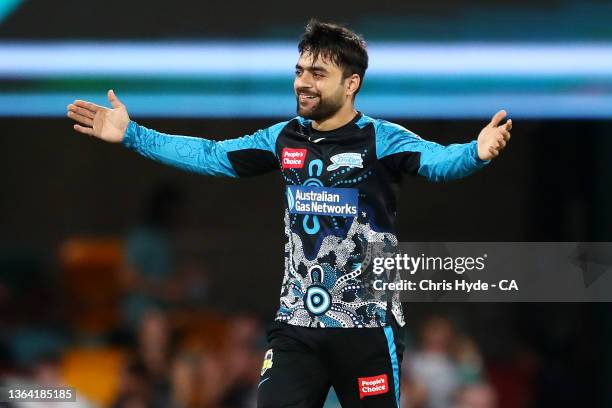 Rashid Khan of the Strikers celebrates dismissing Mujeeb Ur Rahman of the Heat during the Men's Big Bash League match between the Brisbane Heat and...