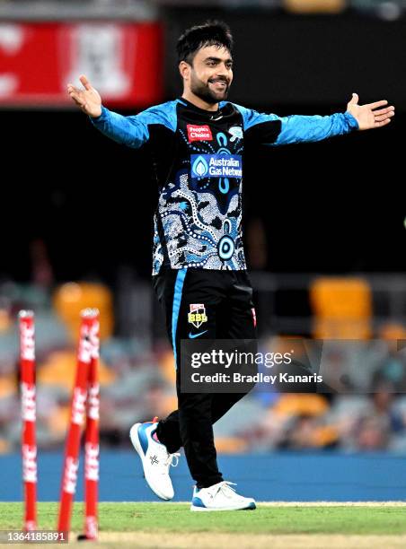 Rashid Khan of the Strikers celebrates taking the wicket of Mujeeb Ur Rahman of the Heat during the Men's Big Bash League match between the Brisbane...