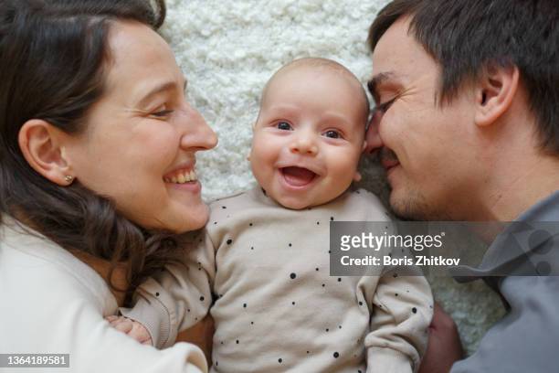 young family. - mum dad and baby stock pictures, royalty-free photos & images