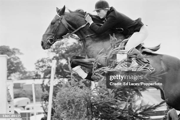 English equestrian show jumper Marion Coakes riding Stroller during competition in the Wills August Stakes at the All England Jumping Course in...