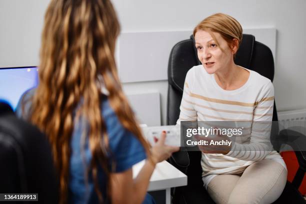 doctor having a consultation with a patient - dermatologists talking to each other patient stock pictures, royalty-free photos & images