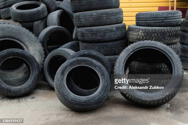 old worn-out car tires from cars and trucks are piled up. the concept of environmental protection, acceptance for secondary use. - dustbin lorry stock pictures, royalty-free photos & images