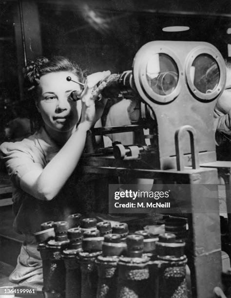Assembly worker Regina Norris collimating 7 x 50 lenses for use in binoculars using an optical collimator at a Ministry of Supply assembly plant on...