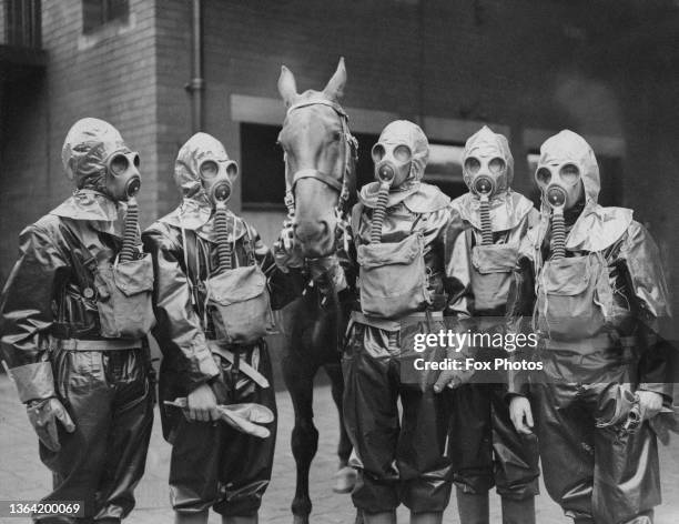 Members of the West Riding Police Service wearing protective clothing and gas masks during an anti gas air raid training exercise with their...