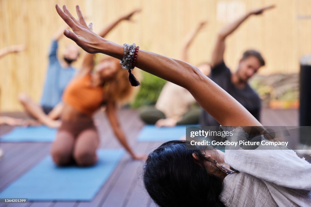 Teacher leading students during a yoga class outside