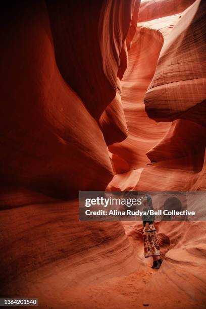 woman standing in a slot canyon - slot canyon fotografías e imágenes de stock