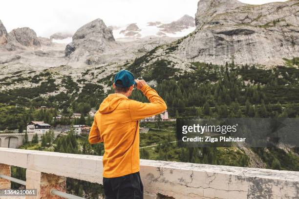 traveler looking at the view of marmolada, dolomites - claus lange stock pictures, royalty-free photos & images