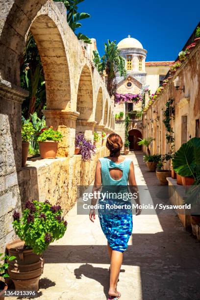 charming woman walking to agia triada monastery, crete - crète photos et images de collection