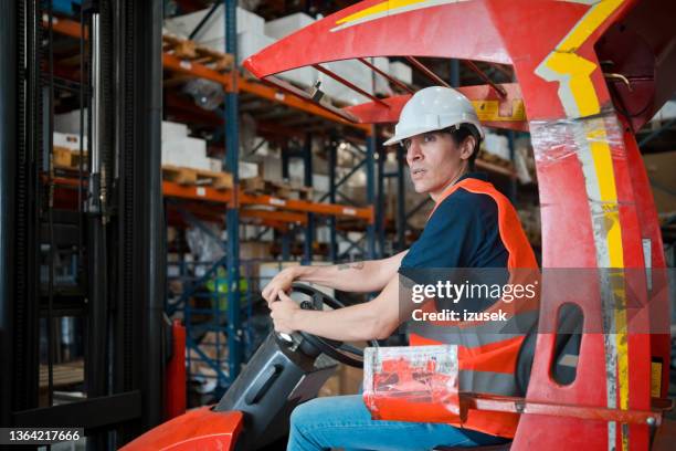 male worker in warehouse - orange shirt stock pictures, royalty-free photos & images