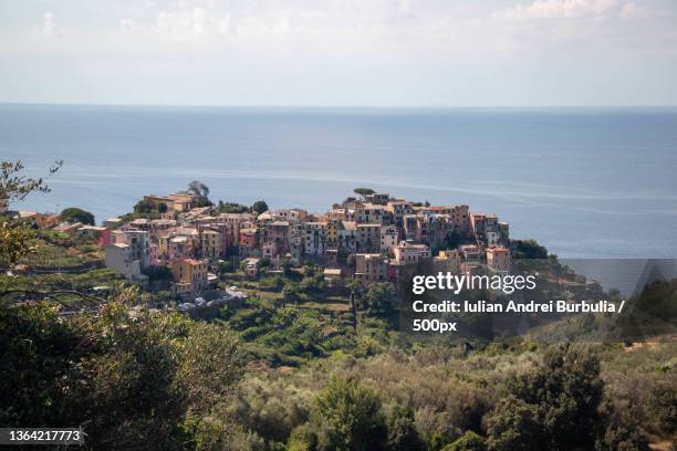 high angle view of townscape by sea against sky - iulian andrei stock-fotos und bilder