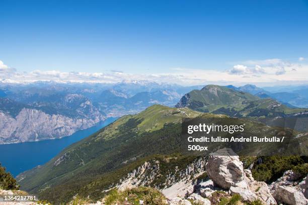 mountain landscape,scenic view of mountains against blue sky - iulian andrei stock-fotos und bilder